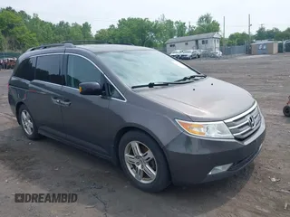 2013 Honda Odyssey Touring with VIN 5FNRL5H97DB071394, listed as a IAAI auction lot 42511829 with 167,154 mi miles and . Bid and sale history available at DreamBid. Image 1.