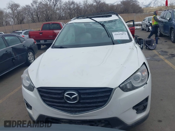 2016 Mazda CX-5 Grand Touring z VIN JM3KE2DY8G0885006, wystawiony jako IAAI lot #41615873 z przebiegiem 118 890 mil mil oraz . Historia ofert i sprzedaży dostępna na DreamBid. Obrazek 12.