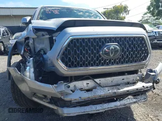 2018 Toyota Tacoma SR z VIN 3TMCZ5AN7JM156092, wystawiony jako IAAI lot #41642391 z przebiegiem 65 805 mil mil oraz . Historia ofert i sprzedaży dostępna na DreamBid. Obrazek 19.