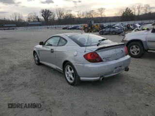 2003 Hyundai Tiburon GT z VIN KMHHN65F63U064962, wystawiony jako Copart lot #44804045 z przebiegiem 186 171 mil mil oraz Szkoda całkowita • Salvage title. Historia ofert i sprzedaży dostępna na DreamBid. Obrazek 2.