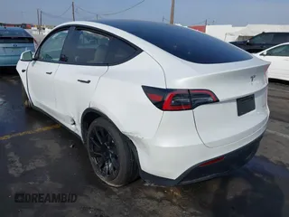 2023 Tesla Model Y Long Range with VIN 7SAYGDEE3PF900030, listed as a IAAI auction lot 41147192 with 13,903 mi miles and . Bid and sale history available at DreamBid. Image 3.