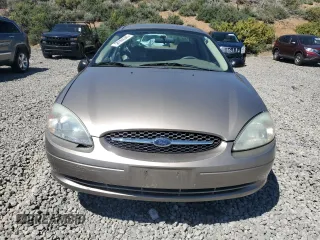 2003 Ford Taurus LX Standard z VIN 1FAFP52U63G277370, wystawiony jako Copart lot #56184345 z przebiegiem 115 778 mil mil oraz Szkoda całkowita • Salvage title. Historia ofert i sprzedaży dostępna na DreamBid. Obrazek 5.