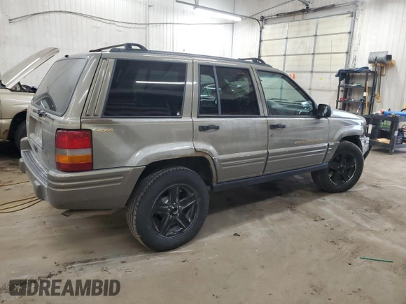 1996 Jeep Grand Cherokee Limited z VIN 1J4GZ78S5TC210710, wystawiony jako Copart lot #81307904 z przebiegiem 285 169 mil mil oraz Szkoda całkowita • Salvage title. Historia ofert i sprzedaży dostępna na DreamBid. Obrazek 3.