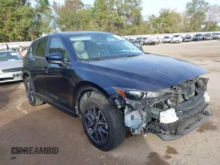 2018 Mazda CX-5 Touring z VIN JM3KFACM0J1389057, wystawiony jako IAAI lot #40922679 z przebiegiem 140 026 mil mil oraz . Historia ofert i sprzedaży dostępna na DreamBid. Obrazek 1.