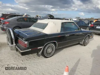 1985 Chrysler LeBaron Mark Cross z VIN 1C3BC55E0FG160918, wystawiony jako Copart lot #76659284 z przebiegiem Nie podano mil oraz Szkody całkowita. Historia ofert i sprzedaży dostępna na DreamBid. Obrazek 3.