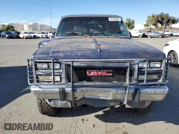 1991 GMC Suburban z VIN 1GKEV16K9MF510909, wystawiony jako Copart lot #81326004 z przebiegiem 216 778 mil mil oraz Tytuł czysty. Historia ofert i sprzedaży dostępna na DreamBid. Obrazek 5.