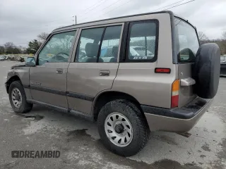 1997 Suzuki Sidekick JX z VIN 2S3TD03V4V6403519, wystawiony jako Copart lot #49666085 z przebiegiem 54 577 mil mil oraz Szkoda całkowita • Salvage title. Historia ofert i sprzedaży dostępna na DreamBid. Obrazek 2.