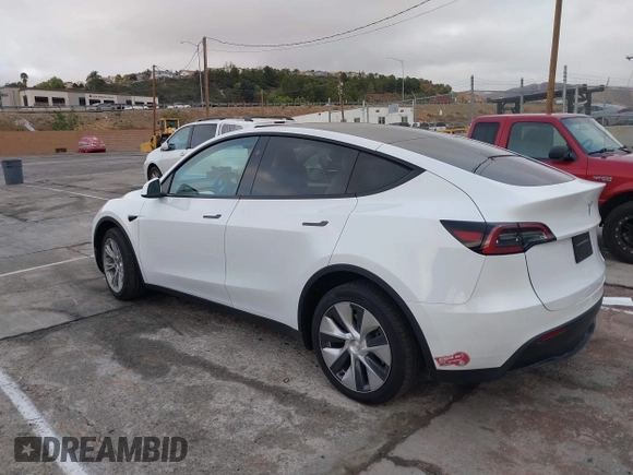 2023 Tesla Model Y Long Range with VIN 7SAYGDEE2PF874729, listed as a IAAI auction lot 41518376 with 10,927 mi miles and . Bid and sale history available at DreamBid. Image 3.