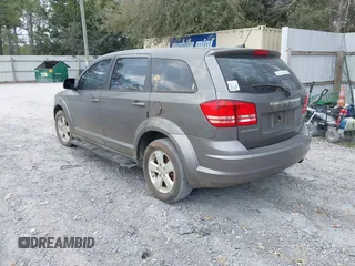 2013 Dodge Journey SE z VIN 3C4PDCAB2DT577805, wystawiony jako IAAI lot #41674351 z przebiegiem 183 006 mil mil oraz . Historia ofert i sprzedaży dostępna na DreamBid. Obrazek 3.