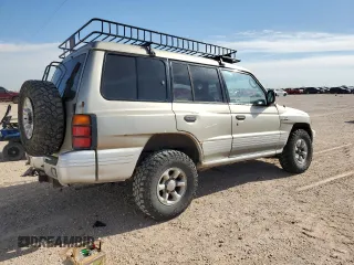 1998 Mitsubishi Montero z VIN JA4MR51R0WJ000921, wystawiony jako Copart lot #56250965 z przebiegiem 181 293 mil mil oraz Szkoda całkowita • Salvage title. Historia ofert i sprzedaży dostępna na DreamBid. Obrazek 3.