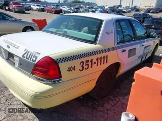 1999 Ford Crown Victoria Police with VIN 2FAFP71WXXX239705, listed as a IAAI auction lot 41601390 with 161,454 mi miles. Bid and sale history available at carsss.com. Image 4.