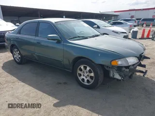 1999 Mazda 626 LX z VIN 1YVGF22D6X5888804, wystawiony jako IAAI lot #41830899 z przebiegiem 190 547 mil mil oraz . Historia ofert i sprzedaży dostępna na DreamBid. Obrazek 1.