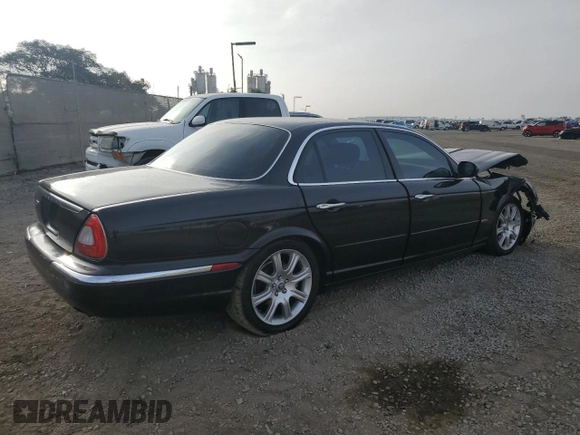 2004 Jaguar XJ with VIN SAJEA71C54SG01455, listed as a Copart auction lot 86591014 with 83,977 mi miles and Salvage Title. Bid and sale history available at carsss.com. Image 3.