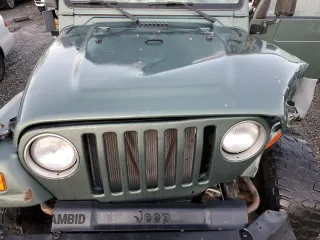 2000 Jeep Wrangler Sport with VIN 1J4FA49S1YP748529, listed as a Copart auction lot 77041924 with 154,949 mi miles and Salvage Title. Bid and sale history available at carsss.com. Image 11.