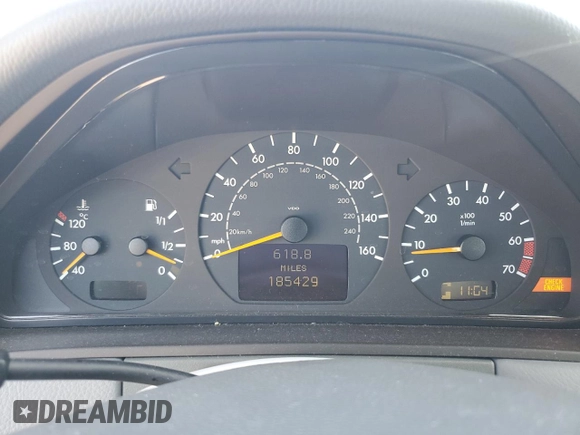 2000 Mercedes-Benz E-Class with VIN WDBJF70JXYB091085, listed as a Copart auction lot 77136484 with 185,429 mi miles and Salvage Title. Bid and sale history available at carsss.com. Image 9.