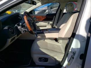 2017 Jaguar XJ with VIN SAJWJ2GD4H8W12163, listed as a Copart auction lot 86993064 with 63,697 mi miles and Salvage Title. Bid and sale history available at carsss.com. Image 7.