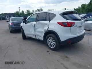 2014 Mazda CX-5 Touring z VIN JM3KE4CY9E0373359, wystawiony jako IAAI lot #42209277 z przebiegiem 106 493 mil mil oraz . Historia ofert i sprzedaży dostępna na DreamBid. Obrazek 3.