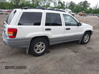 2000 Jeep Grand Cherokee Laredo z VIN 1J4GW48S2YC390226, wystawiony jako IAAI lot #42326715 z przebiegiem 273 806 mil mil oraz . Historia ofert i sprzedaży dostępna na DreamBid. Obrazek 4.