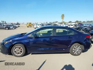 2021 Toyota Corolla Hybrid LE with VIN JTDEAMDEXMJ018828, listed as a IAAI auction lot 41633192 with 63,302 mi miles. Bid and sale history available at carsss.com. Image 15.