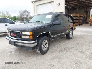 1996 GMC Yukon with VIN 1GKEK13R0TJ739663, listed as a IAAI auction lot 41942883 with 411,219 mi miles. Bid and sale history available at carsss.com. Image 2.