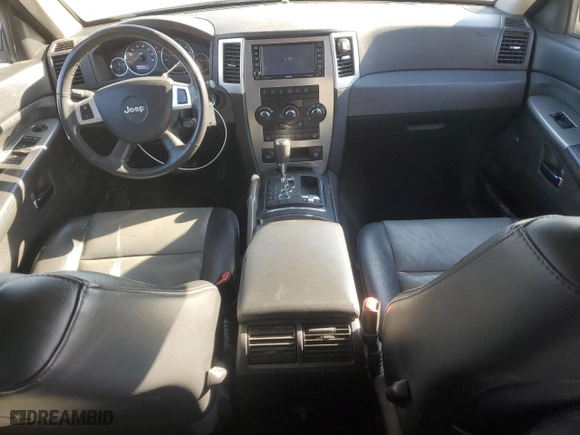 2010 Jeep Grand Cherokee Laredo with VIN 1J4RR4GT1AC106990, listed as a Copart auction lot 87421664 with 106,025 mi miles and Salvage Title. Bid and sale history available at carsss.com. Image 8.