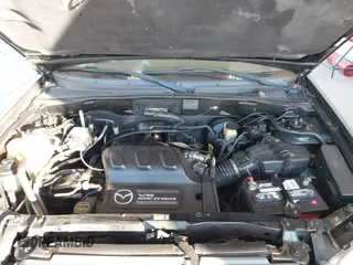 2002 Mazda Tribute LX with VIN 4F2CU08172KM58561, listed as a IAAI auction lot 41435407 with 141,908 mi miles and . Bid and sale history available at carsss.com. Image 10.