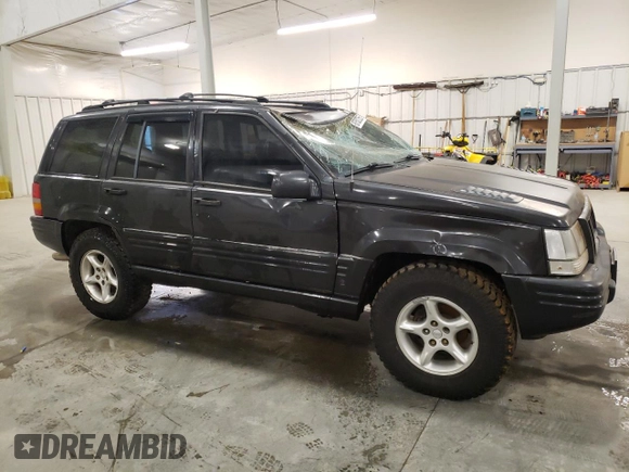 1998 Jeep Grand Cherokee Limited with VIN 1J4GZ88Z3WC165659, listed as a Copart auction lot 87527255 with 203,860 mi miles and Salvage Title. Bid and sale history available at carsss.com. Image 4.