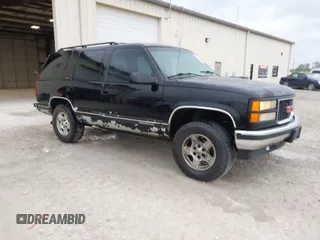 1996 GMC Yukon with VIN 1GKEK13R0TJ739663, listed as a IAAI auction lot 41942883 with 411,219 mi miles. Bid and sale history available at carsss.com. Image 1.