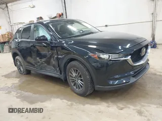 2021 Mazda CX-5 Touring z VIN JM3KFBCM7M1314821, wystawiony jako IAAI lot #42199409 z przebiegiem 51 542 mil mil oraz . Historia ofert i sprzedaży dostępna na DreamBid. Obrazek 1.