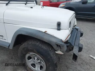 2006 Jeep Wrangler Sport Right Hand Drive with VIN 1J4F449S16P709895, listed as a IAAI auction lot 41349311 with 157,125 mi miles. Bid and sale history available at carsss.com. Image 17.