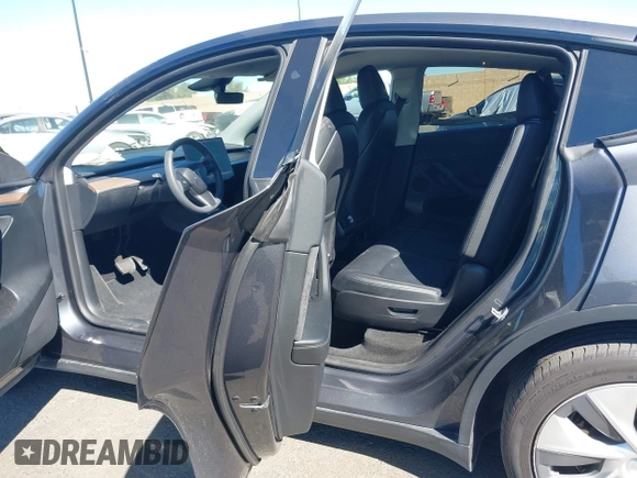2023 Tesla Model Y Long Range with VIN 7SAYGAEE8PF976969, listed as a IAAI auction lot 41877784 with 25,896 mi miles. Bid and sale history available at carsss.com. Image 8.