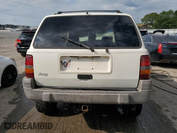 1996 Jeep Grand Cherokee Laredo with VIN 1J4GZ58S9TC277492, listed as a Copart auction lot 66732404 with Not provided miles and Salvage title. Bid and sale history available at DreamBid. Image 6.