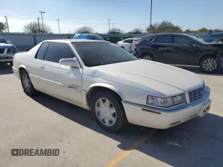2000 Cadillac Eldorado z VIN 1G6EL12Y0YB702117, wystawiony jako Copart lot #80297854 z przebiegiem 124 851 mil mil oraz Szkoda całkowita • Salvage title. Historia ofert i sprzedaży dostępna na DreamBid. Obrazek 4.