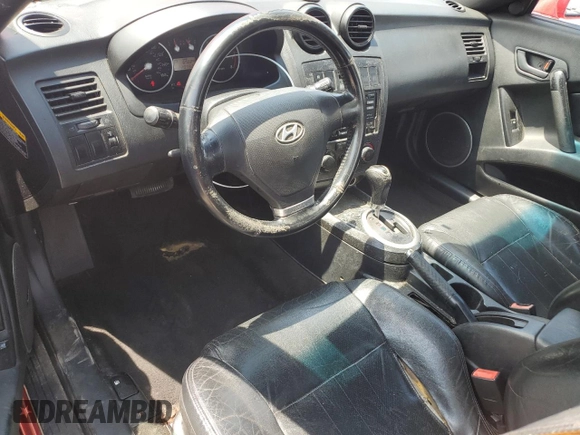 2003 Hyundai Tiburon GT z VIN KMHHN65F33U088538, wystawiony jako Copart lot #54320955 z przebiegiem 220 732 mil mil oraz Szkoda całkowita • Salvage title. Historia ofert i sprzedaży dostępna na DreamBid. Obrazek 8.