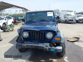 2000 Jeep Wrangler Sport with VIN 1J4FA49S5YP750123, listed as a IAAI auction lot 42060009 with Not Provided miles. Bid and sale history available at carsss.com. Image 12.