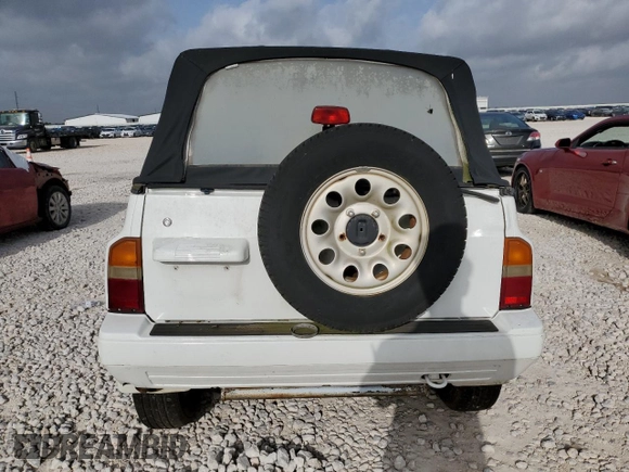 1994 Suzuki Sidekick z VIN 2S3TA01C8R6408593, wystawiony jako Copart lot #65011514 z przebiegiem 248 814 mil mil oraz Tytuł czysty. Historia ofert i sprzedaży dostępna na DreamBid. Obrazek 6.
