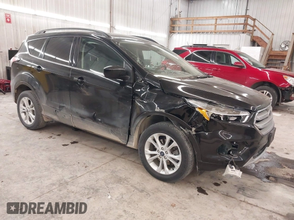 2018 Ford Escape SE z VIN 1FMCU9GD0JUC25636, wystawiony jako IAAI lot #40996760 z przebiegiem 70 097 mil mil oraz . Historia ofert i sprzedaży dostępna na DreamBid. Obrazek 1.