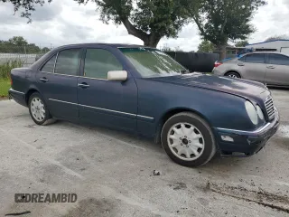 1997 Mercedes-Benz E-Class with VIN WDBJF55F4VJ025769, listed as a Copart auction lot 73460164 with 0 mi miles and Salvage Title. Bid and sale history available at carsss.com. Image 4.