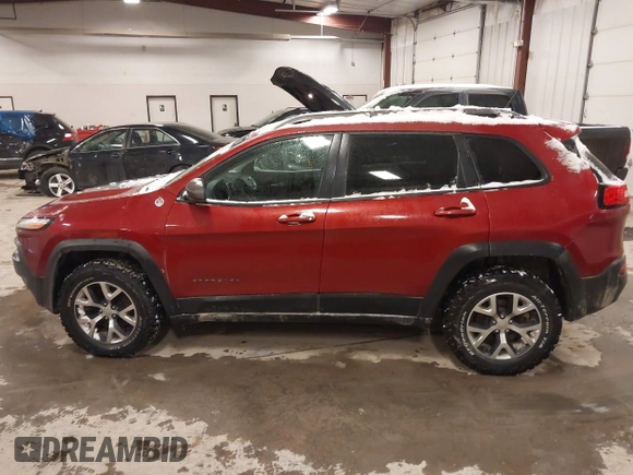 2015 Jeep Cherokee Trailhawk with VIN 1C4PJMBS2FW609999, listed as a IAAI auction lot 41582536 with 133,666 mi miles. Bid and sale history available at carsss.com. Image 14.