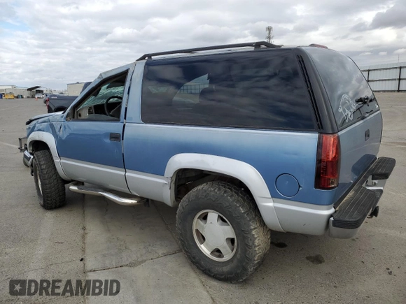 1995 GMC Yukon with VIN 1GKEK18K6SJ710419, listed as a Copart auction lot 80778474 with 215,789 mi miles and Salvage Title. Bid and sale history available at carsss.com. Image 2.