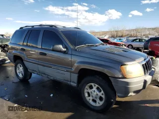 1999 Jeep Grand Cherokee Laredo with VIN 1J4GW58N9XC633464, listed as a Copart auction lot 84682454 with 212,738 mi miles and Salvage title. Bid and sale history available at DreamBid. Image 4.