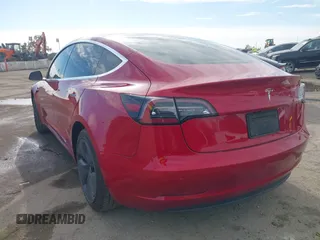 2020 Tesla Model 3 Standard Range Plus with VIN 5YJ3E1EA9LF718027, listed as a IAAI auction lot 41679320 with 68,987 mi miles. Bid and sale history available at carsss.com. Image 3.