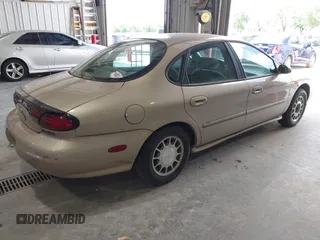 1999 Ford Taurus SE Comfort z VIN 1FAFP53S0XG145837, wystawiony jako IAAI lot #42384370 z przebiegiem 94 870 mil mil oraz . Historia ofert i sprzedaży dostępna na DreamBid. Obrazek 4.