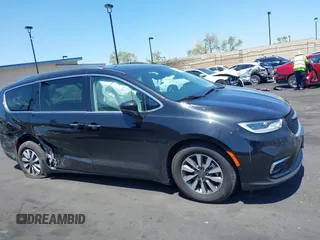 2021 Chrysler Pacifica Hybrid Touring L with VIN 2C4RC1L71MR599631, listed as a IAAI auction lot 42151965 with 67,401 mi miles and . Bid and sale history available at DreamBid. Image 13.