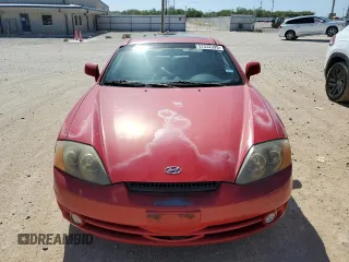2003 Hyundai Tiburon GT z VIN KMHHN65F53U041351, wystawiony jako Copart lot #52332395 z przebiegiem 194 821 mil mil oraz Czysty tytuł • Clean title. Historia ofert i sprzedaży dostępna na DreamBid. Obrazek 5.