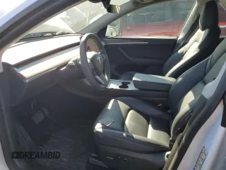2024 Tesla Model Y with VIN 7SAYGDED9RF094494, listed as a Copart auction lot 50298115 with 7,858 mi miles and Salvage Title. Bid and sale history available at DreamBid. Image 7.