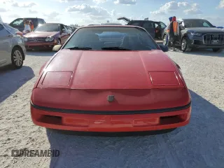 1988 Pontiac Fiero z VIN 1G2PE11R1JP219470, wystawiony jako Copart lot #77772864 z przebiegiem 94 011 mil mil oraz Szkody całkowita. Historia ofert i sprzedaży dostępna na DreamBid. Obrazek 5.