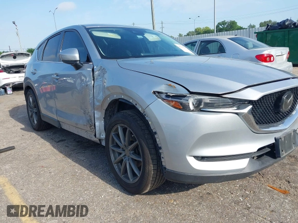 2020 Mazda CX-5 Grand Touring with VIN JM3KFADM5L0739306, listed as a IAAI auction lot 42215667 with 126,100 mi miles and . Bid and sale history available at DreamBid. Image 1.