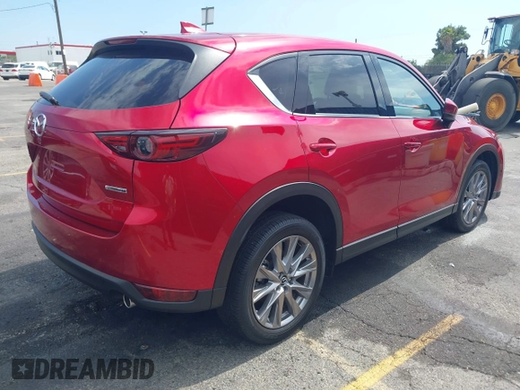 2021 Mazda CX-5 Grand Touring with VIN JM3KFADM6M1373111, listed as a IAAI auction lot 42784431 with 14,374 mi miles and . Bid and sale history available at DreamBid. Image 4.