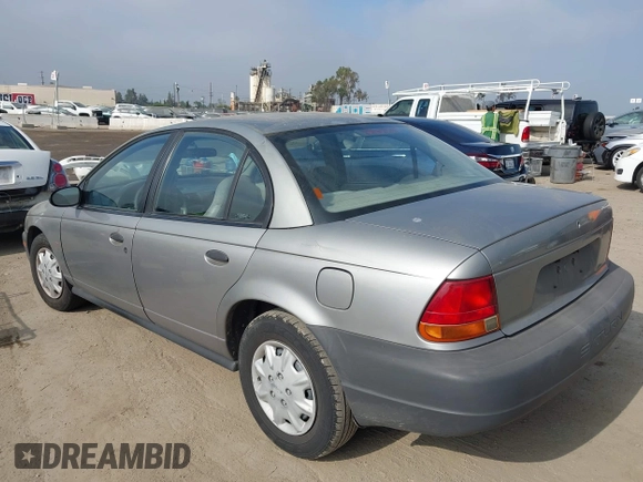 1999 Saturn SL z VIN 1G8ZH5280XZ249494, wystawiony jako IAAI lot #42347493 z przebiegiem 106 491 mil mil oraz . Historia ofert i sprzedaży dostępna na DreamBid. Obrazek 3.